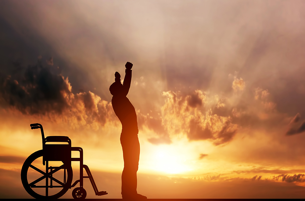 A disabled man standing up from wheelchair at sunset. Positive concept of cure, recovery, medical miracle, hope, insurance etc.