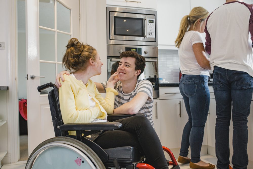 Teenager Playing with Disabled Sister at Home