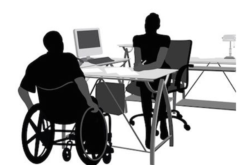 Black and white silhouettes of people in wheelchairs at desks with computers.