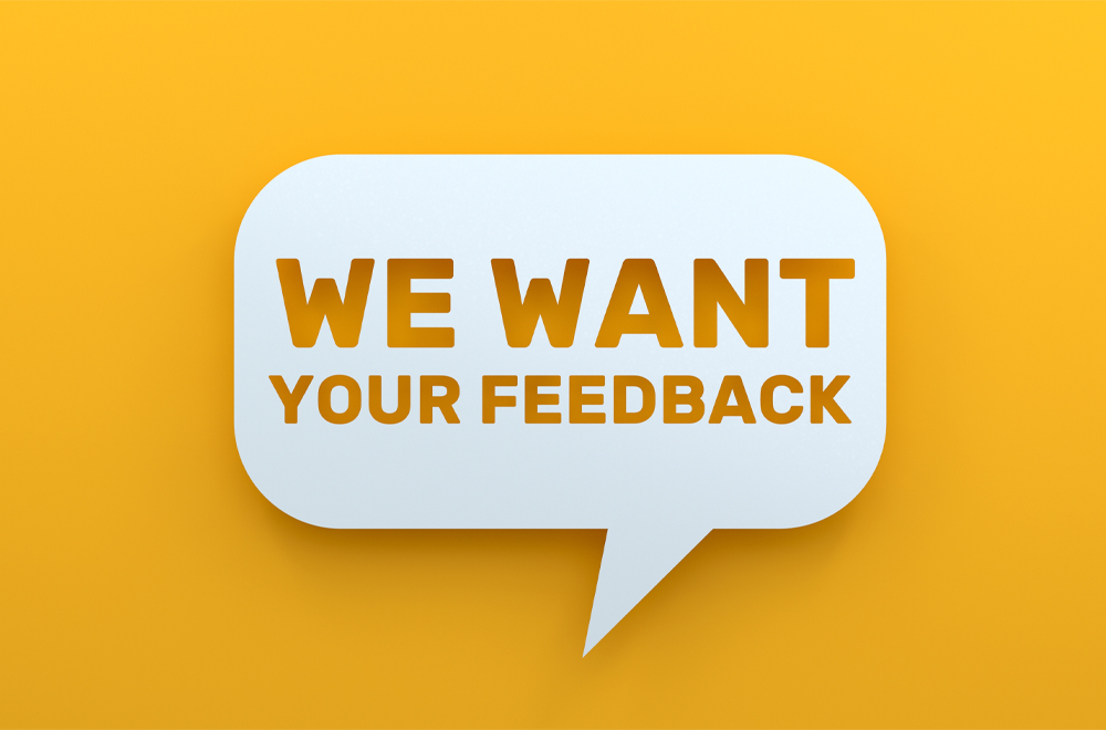 We Want Your Feedback. White Chat Bubble On Yellow Background