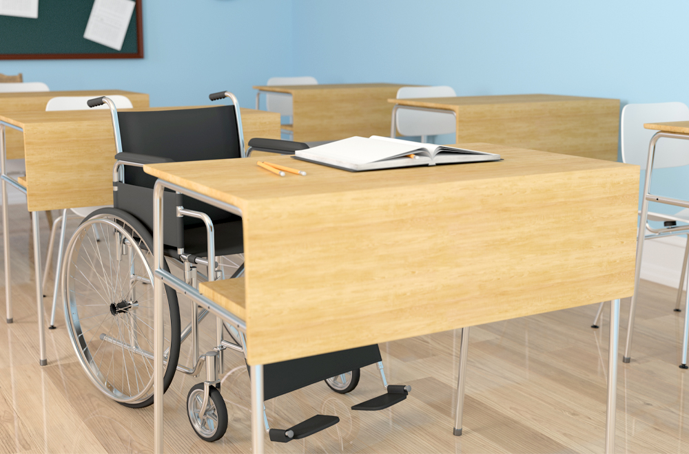 A wheelchair at a school desk.