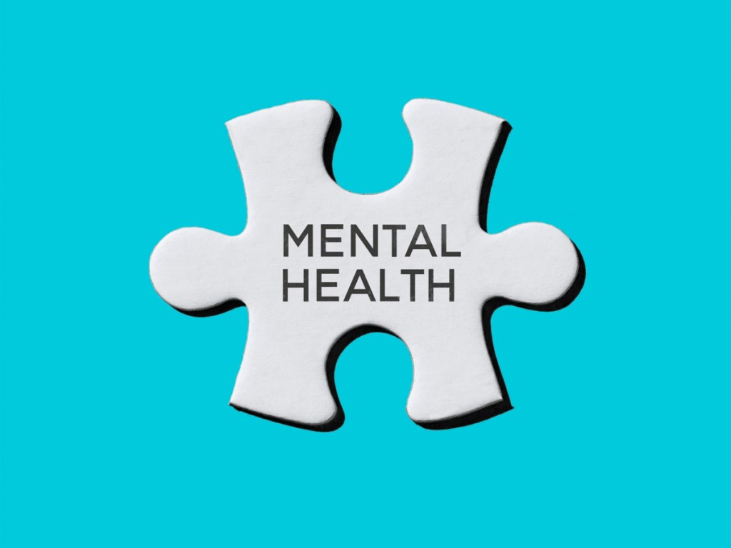 the text mental health written in a white jigsaw puzzle piece on a blue background