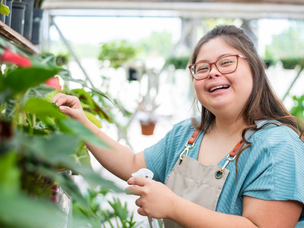 woman with down syndrome florist working in flower shop