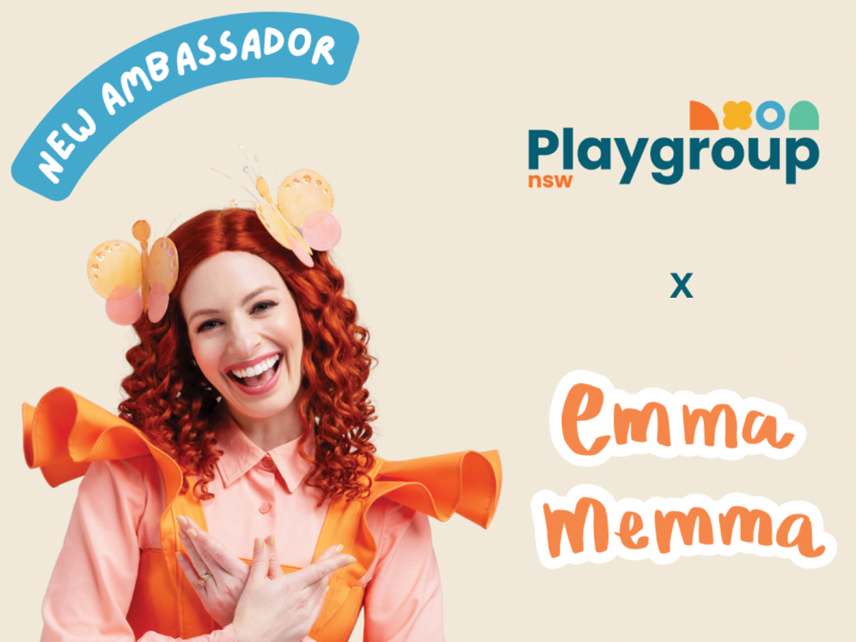 A smiling lady wearing a frilly orange and pink outfit, on a beige background with text saying her name Emma Memma. She has read hair with two pink and yellow butterflies in it.