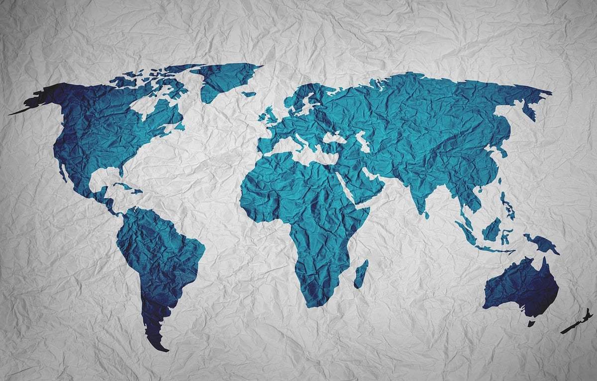 A blue world map on a white background. The countries seem to be textured.