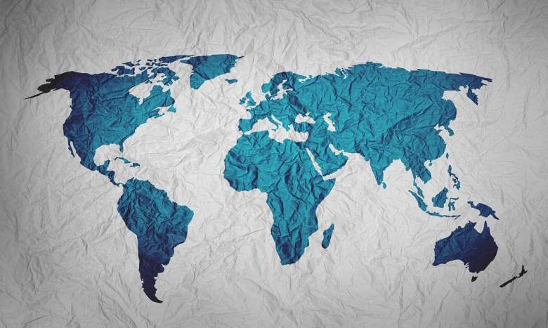 A blue world map on a white background. The countries seem to be textured.